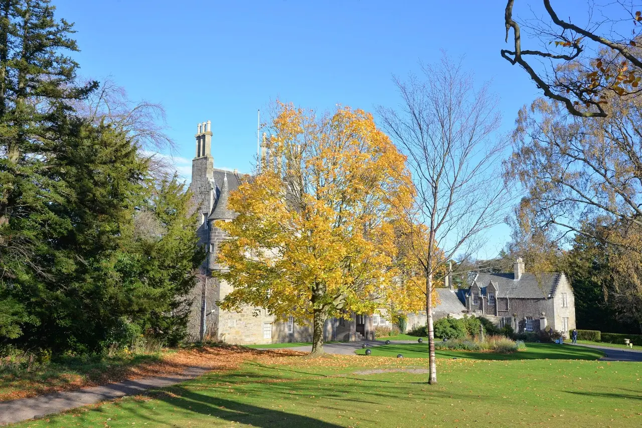 Lauriston Castle partly framed by golden autumn foliage