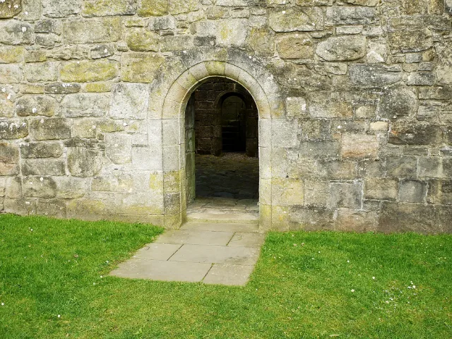 Rounded stone doorway opening into Hermitage Castle